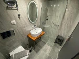 a bathroom with a sink and a mirror at Hotel Almira in Agia Triada
