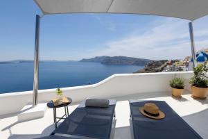 a balcony with a view of the ocean on a boat at Bluedome Cavehouses by Otium Villas in Oia