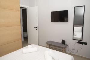 a bedroom with a bed and a mirror and a chair at Friends Luxury Apartment In Marousi in Athens