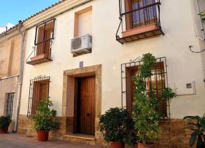 a white building with windows and plants in front of it at Casa en Blanca Murcia, en el centro. C/ Teatro, 5 in Blanca