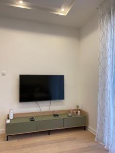 a living room with a flat screen tv on a wall at Apartment Trebinje Sun in Trebinje