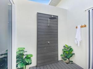 a wooden door in a house with plants at Rock Salt Villa 2 in Picnic Bay