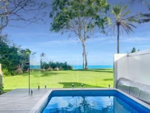 a swimming pool with a view of the ocean at Rock Salt Villa 2 in Picnic Bay