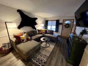 a living room with a couch and a dog hanging on the wall at French Street Retreat Walk Everywhere in Breckenridge