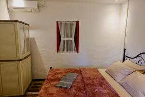 um quarto com uma cama e um quadro na parede em Gubuk Kurnia em Sawan