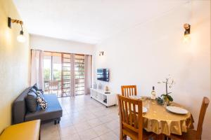 a living room with a table and a dining room at Entire Apartment 5min from Oura Beach in Albufeira