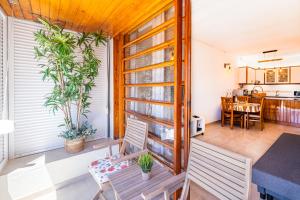 a balcony with a table and chairs and a kitchen at Entire Apartment 5min from Oura Beach in Albufeira