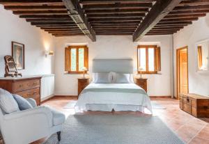 a bedroom with a bed and a chair at Casa Al Colle in San Romano