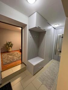 a room with a closet with a mirror and a rug at Villa Monica in Kráľovský Chlmec