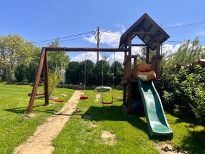 a playground with a slide and a teddy bear on it at Casa Cenţiu in Bran