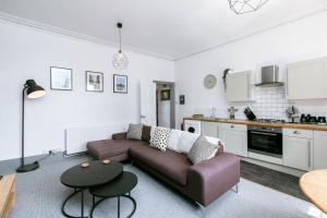a living room with a couch and a kitchen at Peaceful Apartment - Dedicated Free Parking - Walk to Centre, Uni, Hosp - Business and Leisure - Contact For Long Stays in Exeter