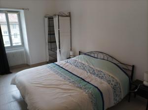 a bedroom with a bed in a room with a window at O'Couvent - Appartement 522 - 2 chambres - 85 m2 - Deuxième étage in Salins-les-Bains