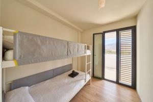 a bedroom with a bunk bed and a window at Casa del Mar in San José +49 photos