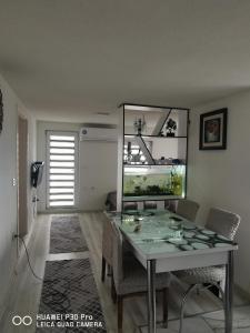 a dining room with a table and a fish tank at Center Struga Apartment in Struga