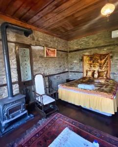 a bedroom with a bed and a wood stove at Şirince Lotus Konakları in Sirince