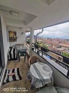 a balcony with a table and a view of a city at Center Struga Apartment in Struga