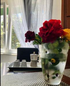 a vase with flowers in it on a table at “La Lavanda” in Maremma in Ischia di Castro