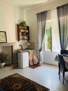 a living room with a table and a window at “La Lavanda” in Maremma in Ischia di Castro