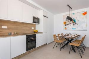 a kitchen and dining room with a table and chairs at Spacious beach apartment with seaview Costa Calida in San Pedro del Pinatar