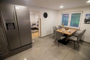 a kitchen and dining room with a table and chairs at GREEN LAND Family Fun Sport Resort in Šmarje pri Jelšah
