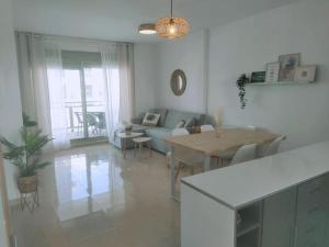 a living room with a couch and a table at Moderno apartamento en Oliva Nova golf & MET in Oliva