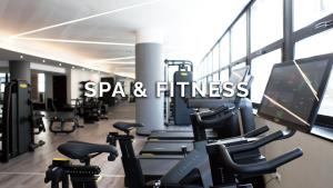 a gym with treadmills and a computer monitor and cardio equipment at The Hive Hotel in Rome