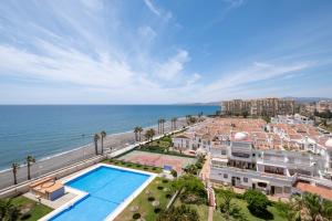 a view of the ocean from a building with a swimming pool at Las Terrazas Primera Línea de playa in Mezquitilla