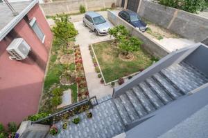 an overhead view of a stairway with a car parked in a yard at Apartmani Bar in Bar