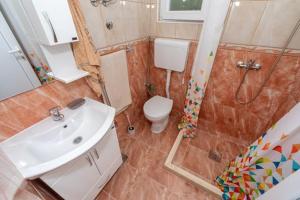 a bathroom with a toilet and a sink and a shower at Apartmani Bar in Bar