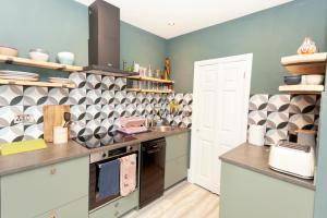 una cucina con lavandino e piano cottura forno superiore di Sundance Cosy Getaway - Annexe a Whitstable