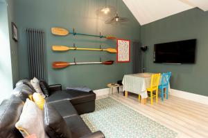 a living room with a couch and a table at Sundance Cosy Getaway - Annexe in Whitstable