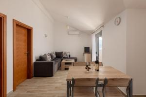 a living room with a table and a couch at Djukanovic Apartments in Bijela