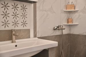 a bathroom with a sink and a shower at Skypiea Room in Agia Anna Naxos