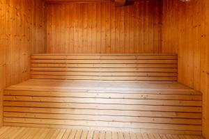 a wooden sauna with a wooden bench in it at Agger Holidays in Vestervig