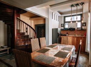 a dining room with a table and a kitchen at Thai Authentic House in Jomtien Beach
