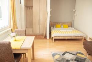 a bedroom with a bed and a table and chairs at Keleti Aparthotel in Budapest