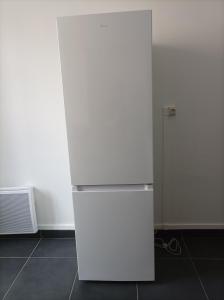 a white refrigerator in a room with a wall at O'Couvent - Appartement 66 m2 - 2 chambres - A523 in Salins-les-Bains