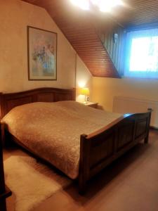 a bedroom with a large bed with a window at Karolina Apartment in Békéscsaba +27 photos