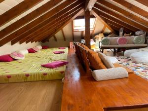 a attic room with two beds and a wooden floor at El palacio de Liaño pool chillout bbq in Liaño