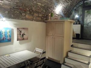 Zimmer mit einem Tisch, einem Schrank und einer Treppe in der Unterkunft Casa Limonaia San Rocco in Limone sul Garda