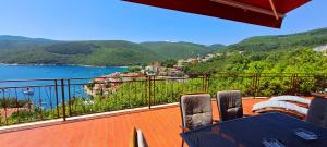 a balcony with a view of a body of water at ISTRIEN-ADRIA in Rabac