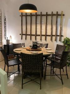 a dining room table and chairs with wine glasses at Vila Mulungu Casa in Mulungu +62 photos