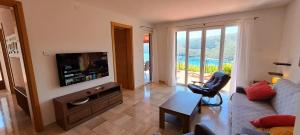 a living room with a couch and a television at ISTRIEN-ADRIA in Rabac