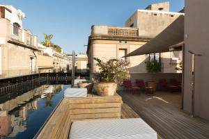 un patio con sillas y una piscina de agua en Hotel Neri – Relais & Chateaux, en Barcelona