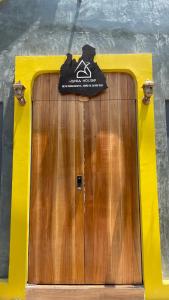 a wooden door with a sign on top of it at VANIA HOUSE - cozy studio near the airport in Ho Chi Minh City