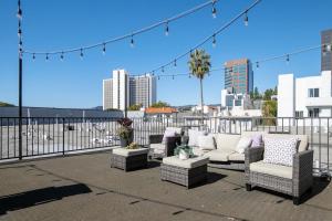 a patio with couches and chairs on a balcony at Westwood 1BR w Rooftop nr Westwood Village LAX-111 in Los Angeles