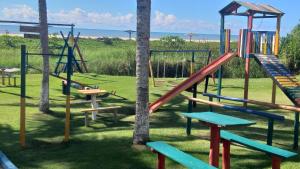 a park with a playground with slides and swings at Casa de Praia, pé na areia Guaratiba Prado - Bahia in Prado