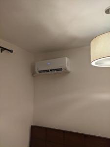 a room with a air conditioner on a white wall at Spacious 3 bedroom apartment with a sea view. in Dawwār Abū Maḩrūs