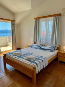 a bedroom with a large bed with a large window at Vespera Apartments in Bol