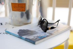 a book with glasses on top of it on a table at Bellini Inn Primo Piano in Naples